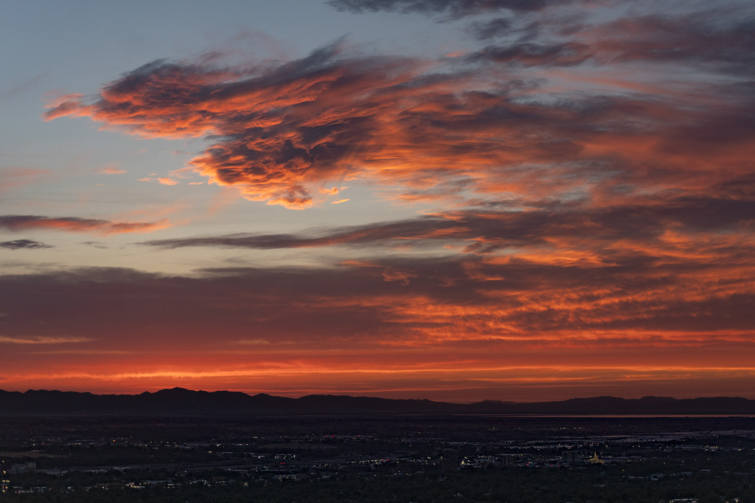 Sunset lit clouds like fire take the form of a kind of dashing creature